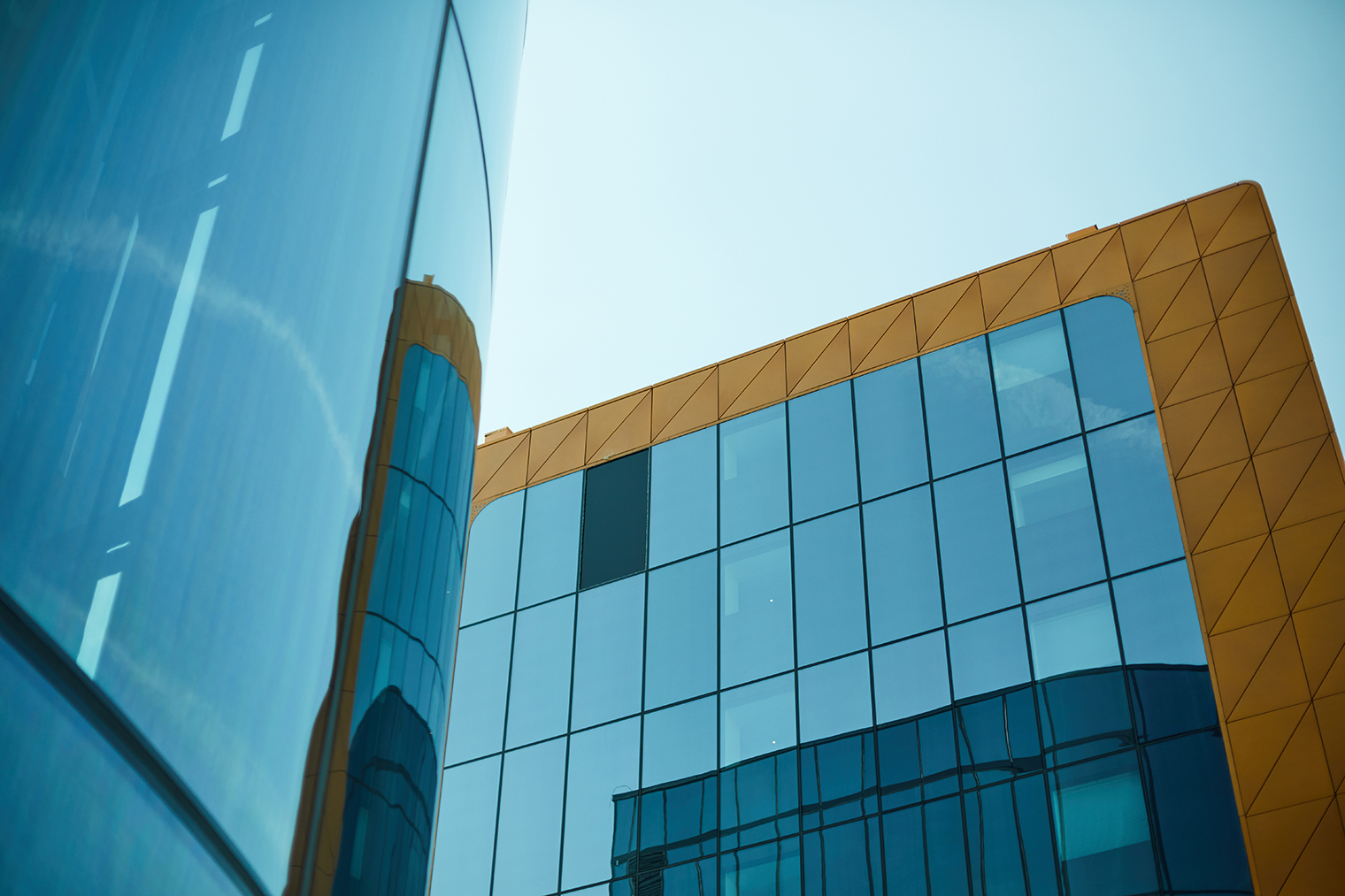 Creative design of financial district building with glassy walls and golden metal frame, modern architecture of big city concept