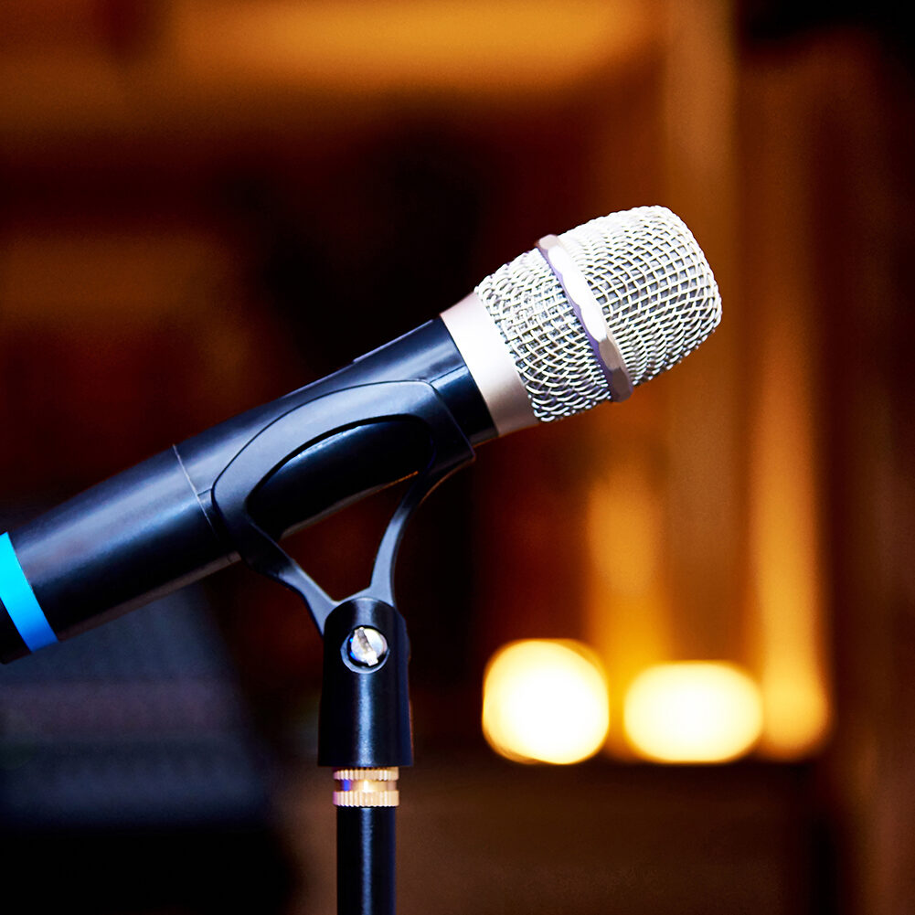 Microphone on the rack close-up on a blurred background Microphone on the rack close-up on a blurred background